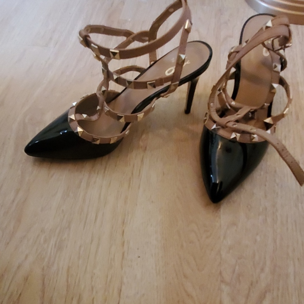 Black, tan, and gold closed toed strap shoes